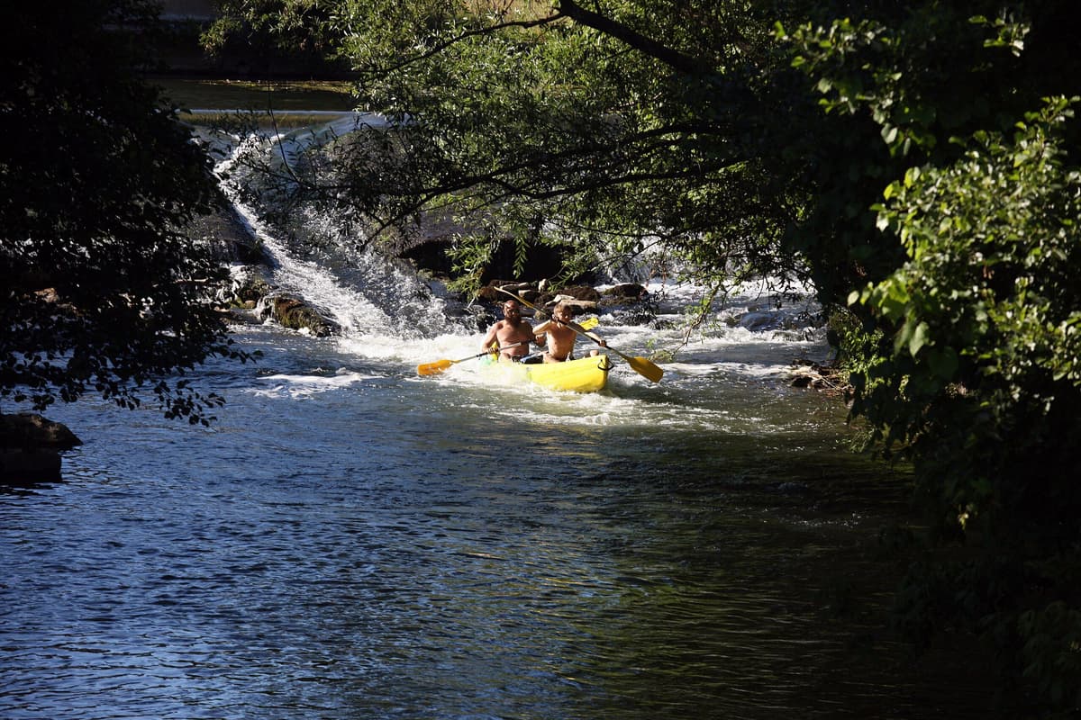 image of men kayaking at a river